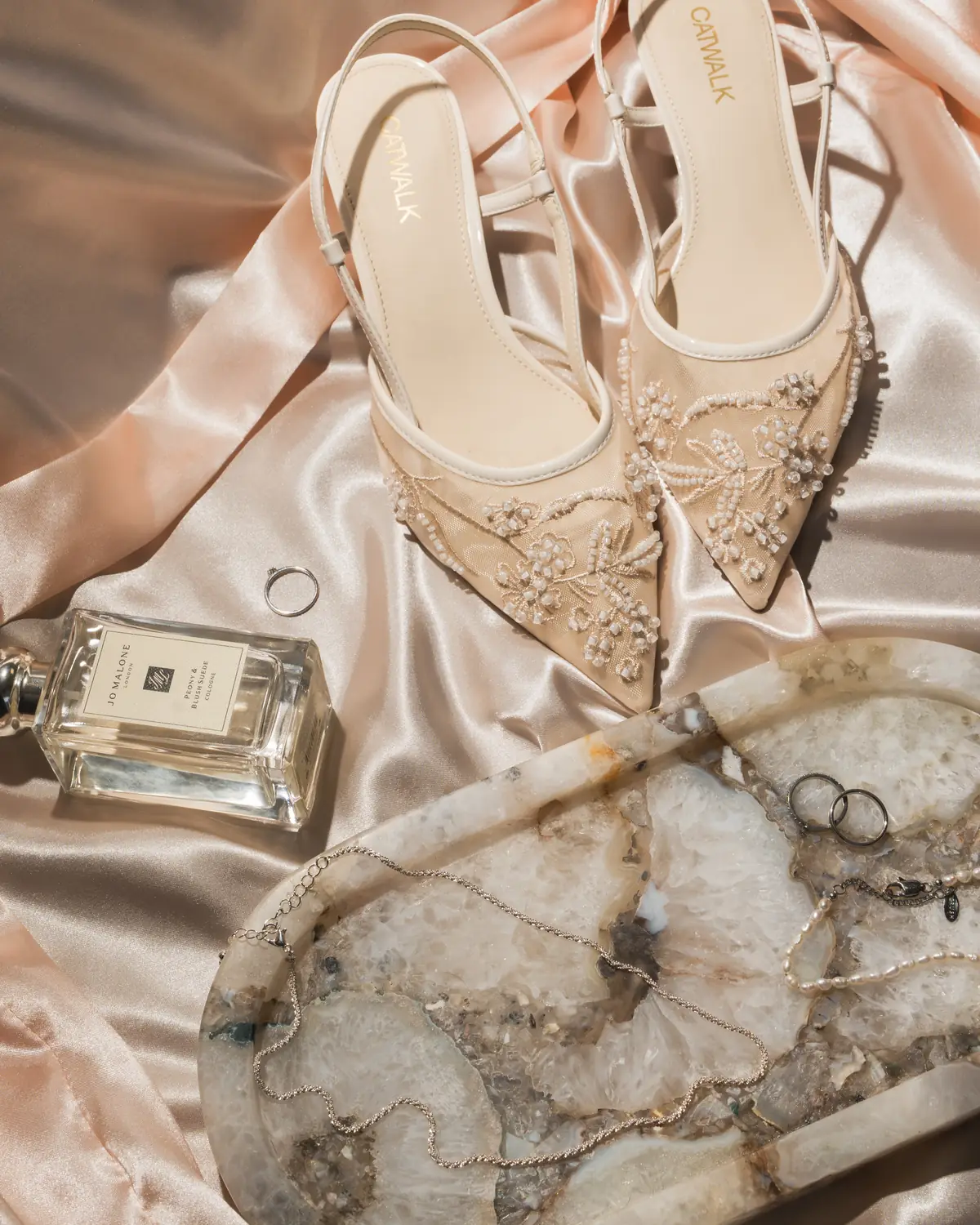 Bridal shoes, jewellery and perfume on the morning of the wedding.