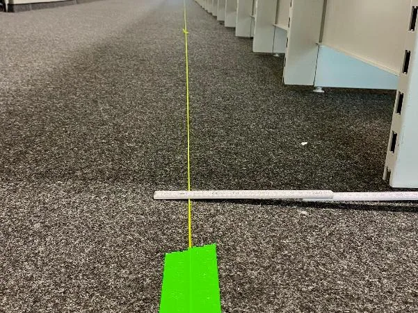 Floor markings to the millimetre: every stand position is measured out before build-up.
