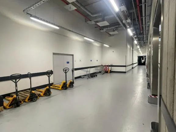 Logistics routes kept clear, with pallet trucks in position.